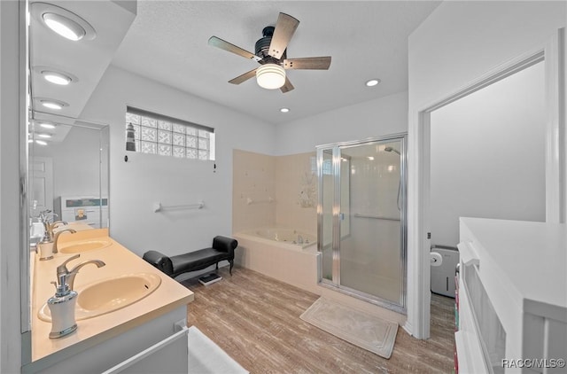 bathroom featuring vanity, ceiling fan, plus walk in shower, and wood-type flooring