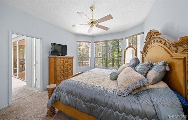 bedroom featuring multiple windows, ceiling fan, and a textured ceiling