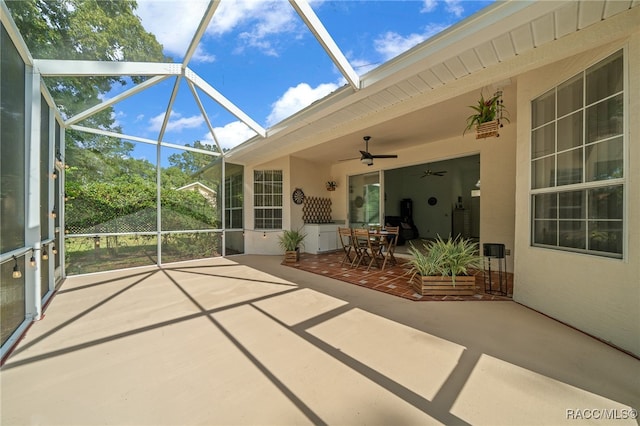 unfurnished sunroom with ceiling fan