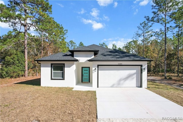 view of front of home with a front yard and a garage