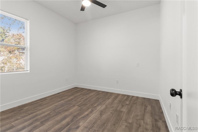 spare room featuring ceiling fan, plenty of natural light, and dark hardwood / wood-style floors