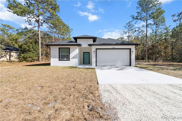 view of front facade with a front yard and a garage