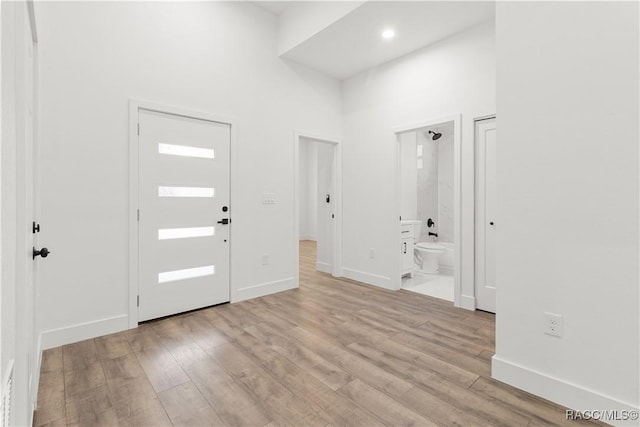 foyer featuring a high ceiling and light hardwood / wood-style floors