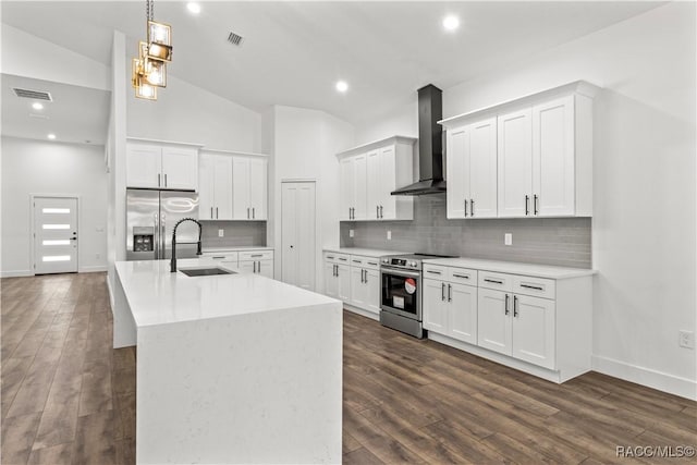 kitchen with dark hardwood / wood-style floors, sink, stainless steel appliances, and wall chimney range hood