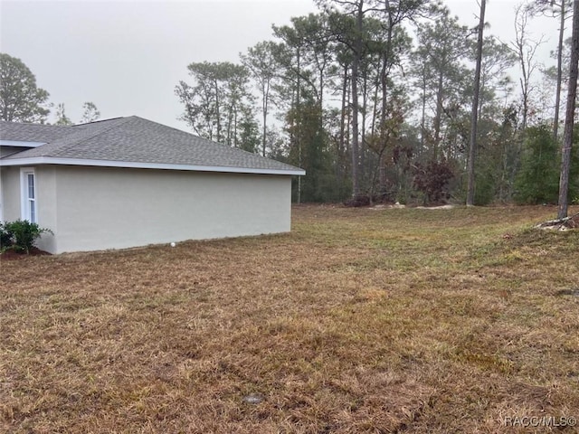 view of property exterior with a yard