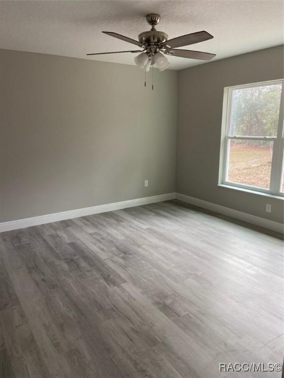 empty room featuring hardwood / wood-style floors and ceiling fan