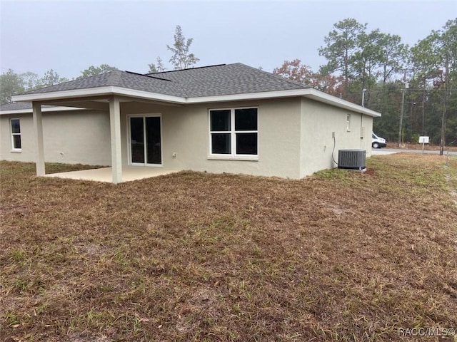 back of property featuring central air condition unit and a patio