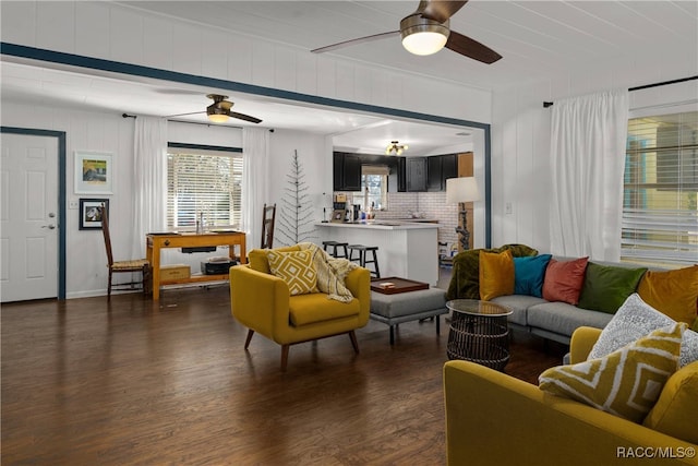 living room with ceiling fan and dark hardwood / wood-style flooring