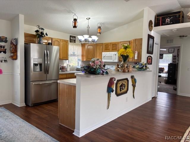 kitchen with pendant lighting, lofted ceiling, a chandelier, dark hardwood / wood-style flooring, and stainless steel refrigerator with ice dispenser