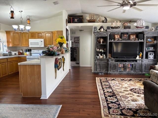 kitchen featuring vaulted ceiling, dark hardwood / wood-style floors, white appliances, and decorative light fixtures