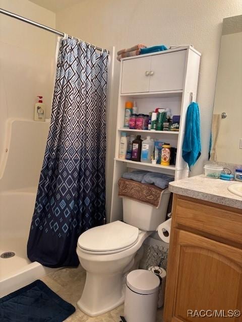 bathroom with vanity, a shower with curtain, and toilet