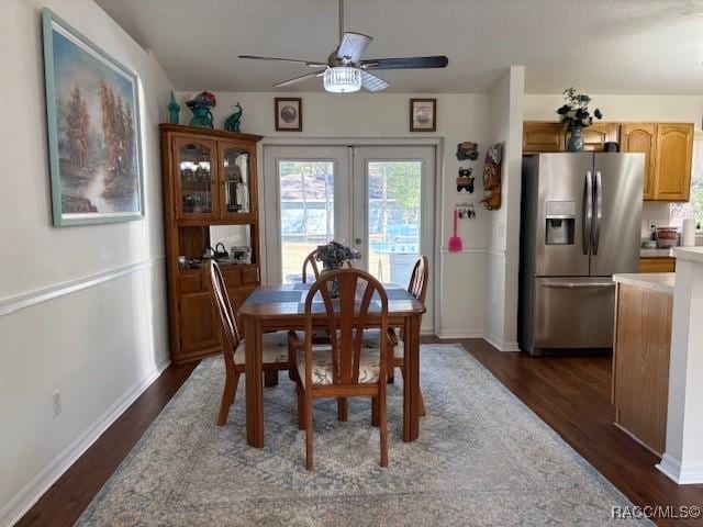 dining room featuring dark wood-type flooring, ceiling fan, and french doors