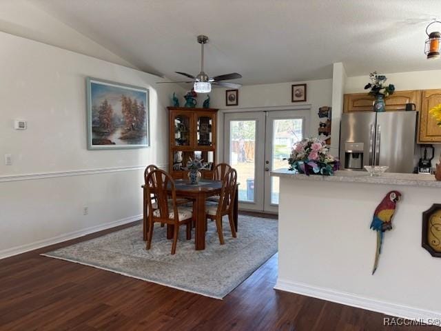 dining area featuring lofted ceiling, dark hardwood / wood-style floors, french doors, and ceiling fan