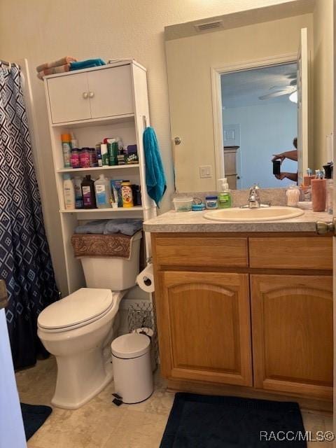 bathroom with vanity, ceiling fan, tile patterned floors, and toilet