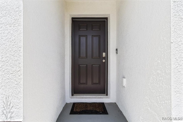 457 W Fairways View Dr, Beverly Hills, FL 34465 - doorway to property featuring stucco siding