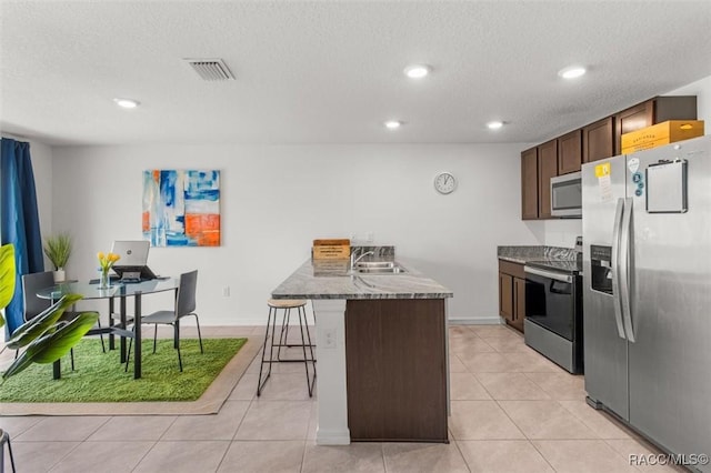 457 W Fairways View Dr, Beverly Hills, FL 34465 - kitchen with appliances with stainless steel finishes, a sink, a breakfast bar area, recessed lighting, and light tile patterned flooring
