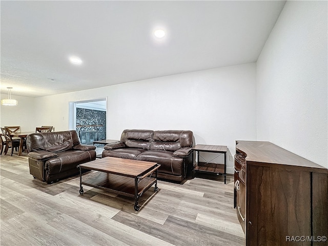 living area with recessed lighting and light wood finished floors