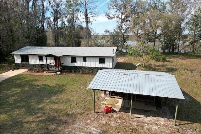 exterior space with a carport and a yard