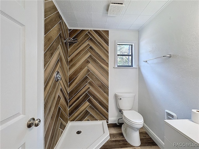 bathroom featuring baseboards, visible vents, toilet, wood finished floors, and a shower stall