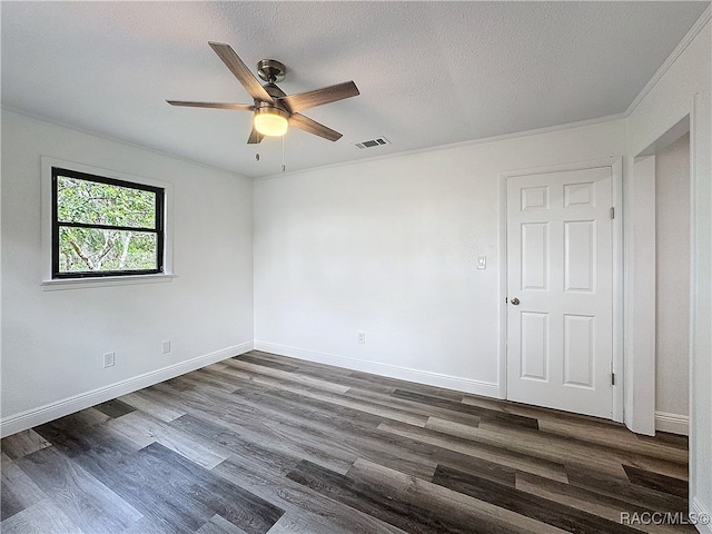 empty room with dark wood-style floors, visible vents, a textured ceiling, and baseboards