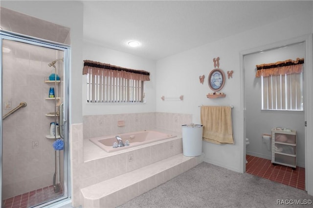 bathroom with toilet, a stall shower, a bath, and tile patterned floors