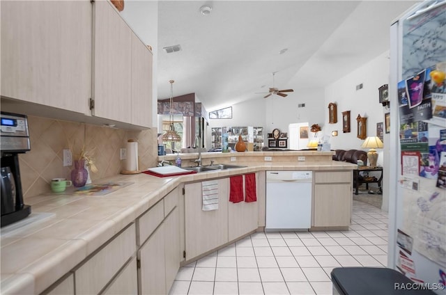 kitchen featuring white appliances, visible vents, tile countertops, open floor plan, and a peninsula