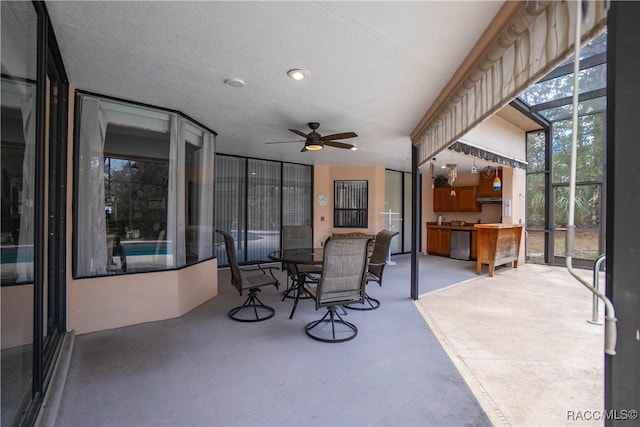 view of patio / terrace featuring outdoor dining space, a lanai, and a ceiling fan