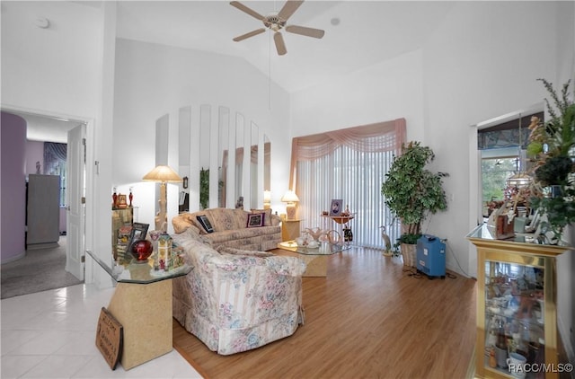 living room with ceiling fan, high vaulted ceiling, and wood finished floors