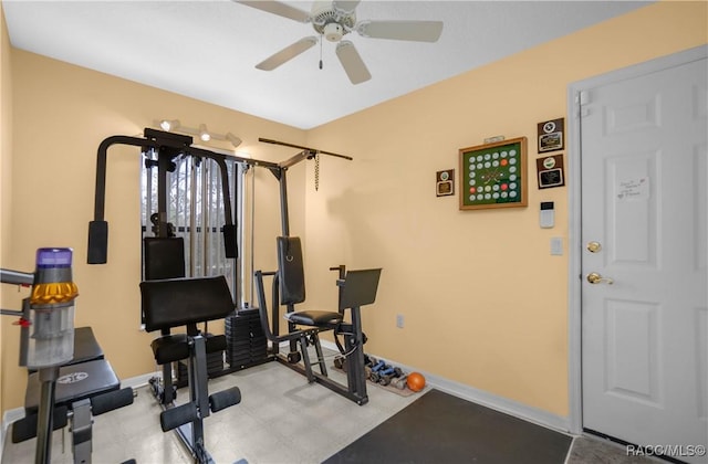 exercise area with ceiling fan and baseboards