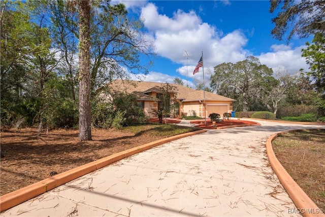 view of front of home featuring an attached garage and concrete driveway