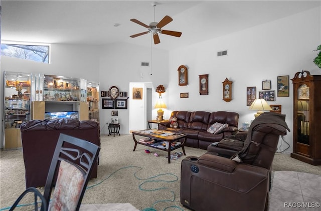 carpeted living room featuring a ceiling fan, bar area, visible vents, and high vaulted ceiling