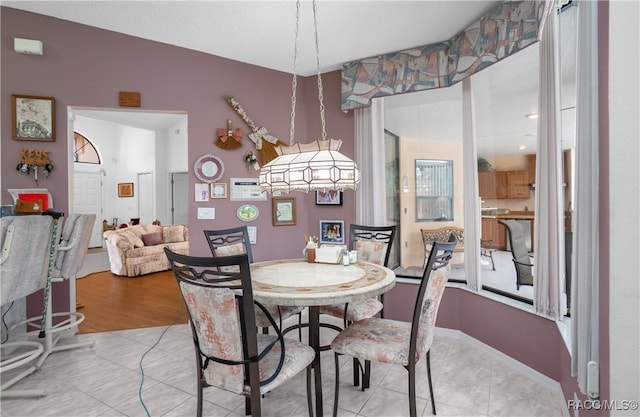 dining space featuring light tile patterned flooring