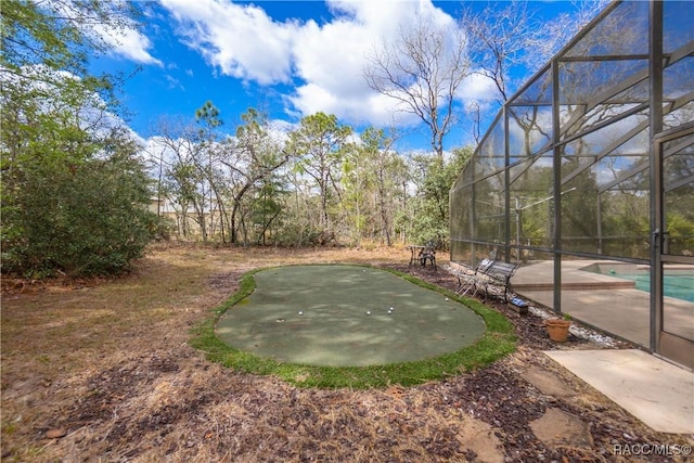 view of yard featuring a patio area, a lanai, and an outdoor pool