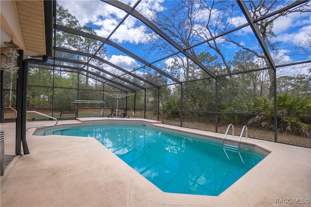 pool with glass enclosure and a patio