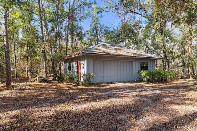 view of property exterior featuring a garage and an outdoor structure