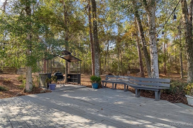 wooden terrace featuring a gazebo