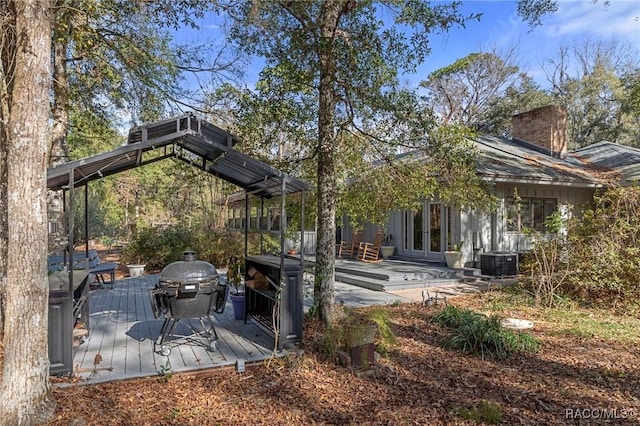 exterior space with french doors, a deck, and cooling unit