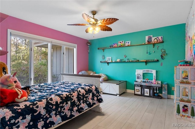 bedroom with ceiling fan and light hardwood / wood-style floors