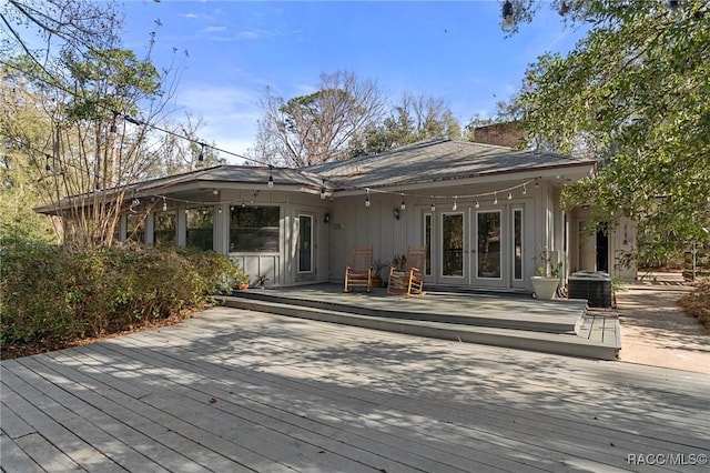 exterior space featuring central AC unit, french doors, and a deck