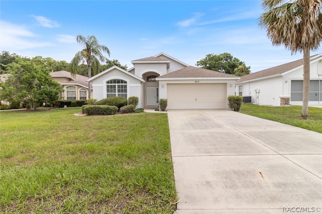 ranch-style house with cooling unit, a front lawn, and a garage