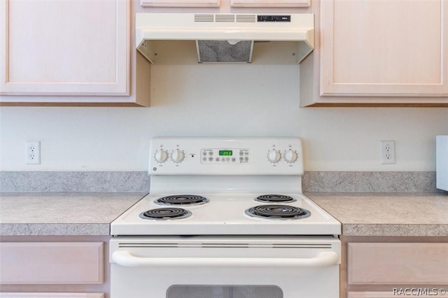 kitchen with white range with electric cooktop, light countertops, and under cabinet range hood