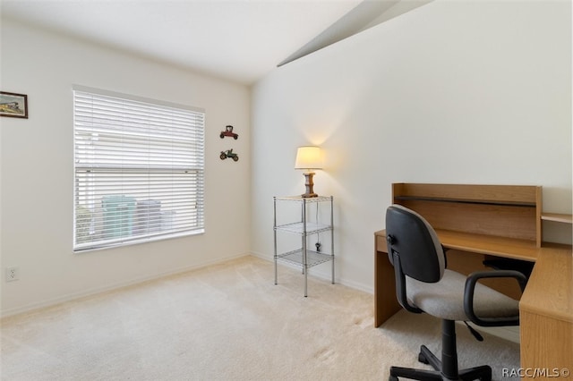 carpeted office with vaulted ceiling