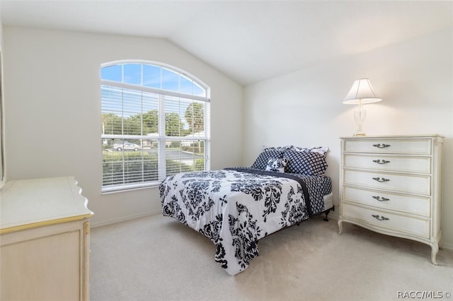 carpeted bedroom featuring lofted ceiling