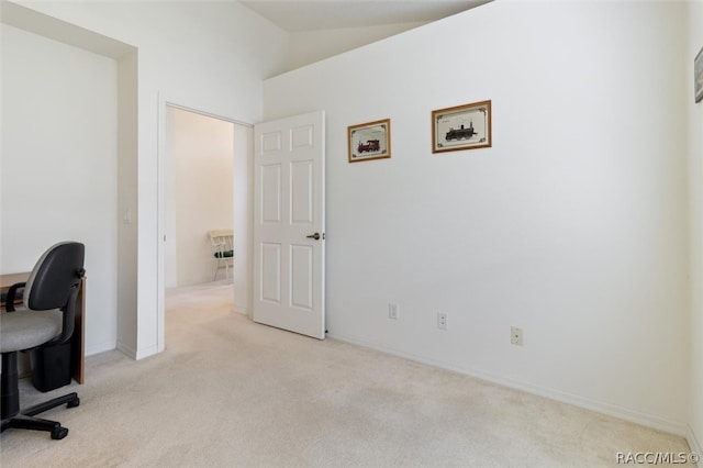 office with light colored carpet and lofted ceiling