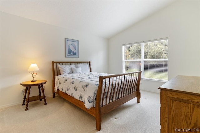 carpeted bedroom with lofted ceiling