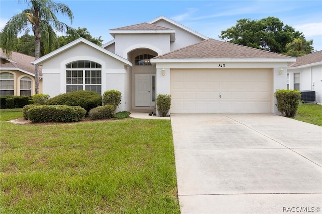 view of front facade featuring central AC, a garage, and a front lawn