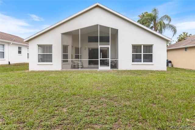 rear view of house featuring a lawn and a patio