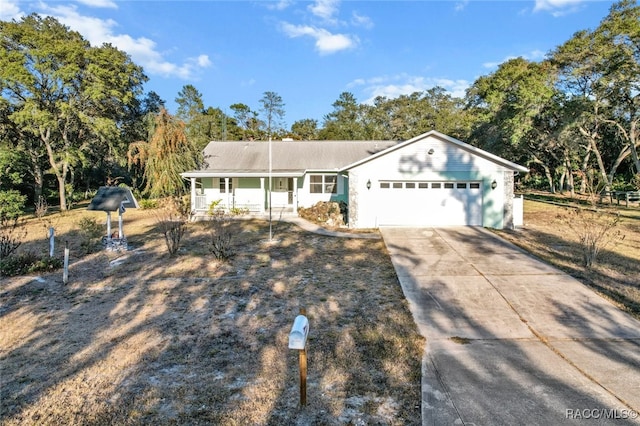 ranch-style home with covered porch and a garage