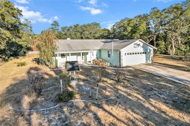 single story home with a porch and a garage