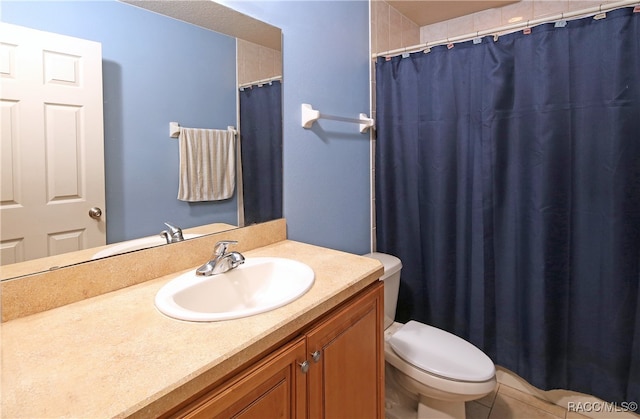 bathroom with tile patterned floors, vanity, and toilet